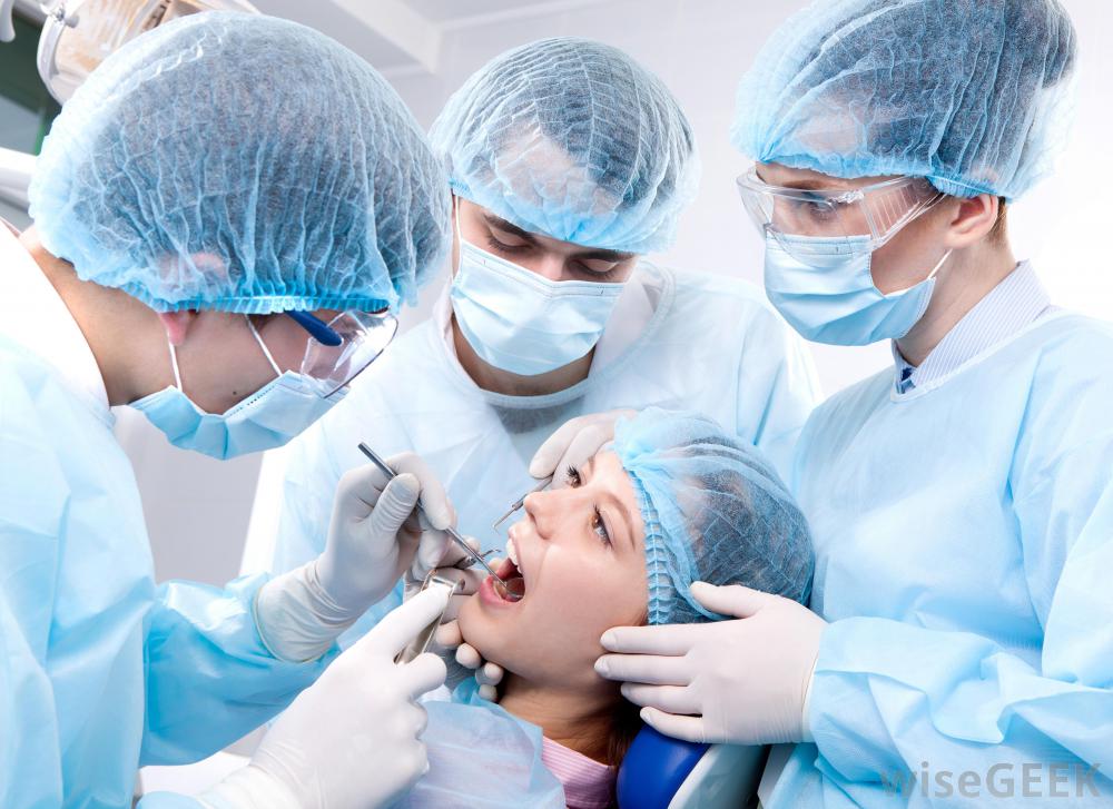 three-dentists-working-on-patients-mouth